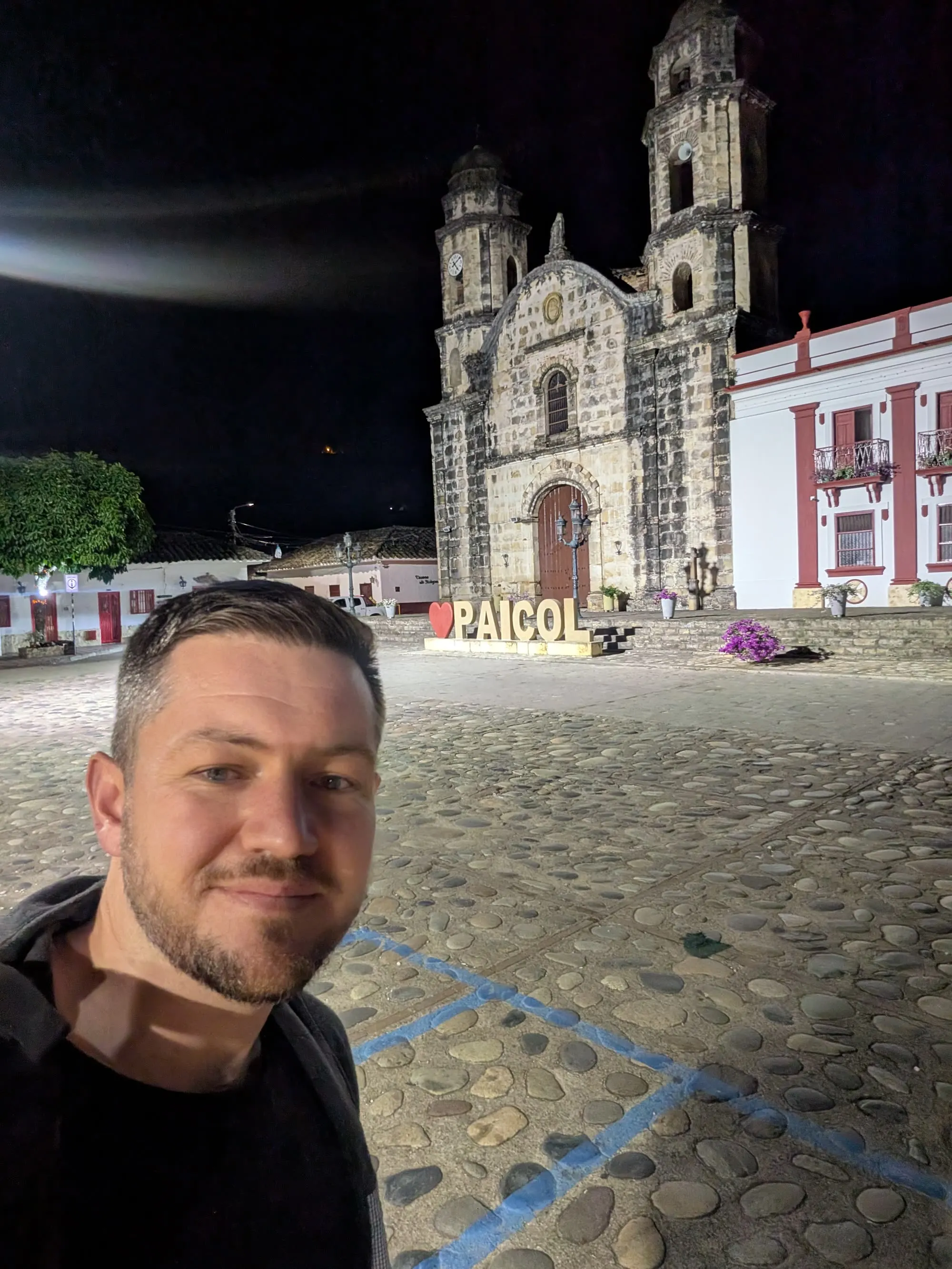 The plaza principal of Paicol before dawn, lit by streetlights